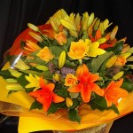 Roses and lilies in a beautiful bunch from your Nelson florist
