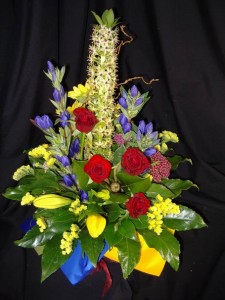 Bright flowers in a box arrangement including roses